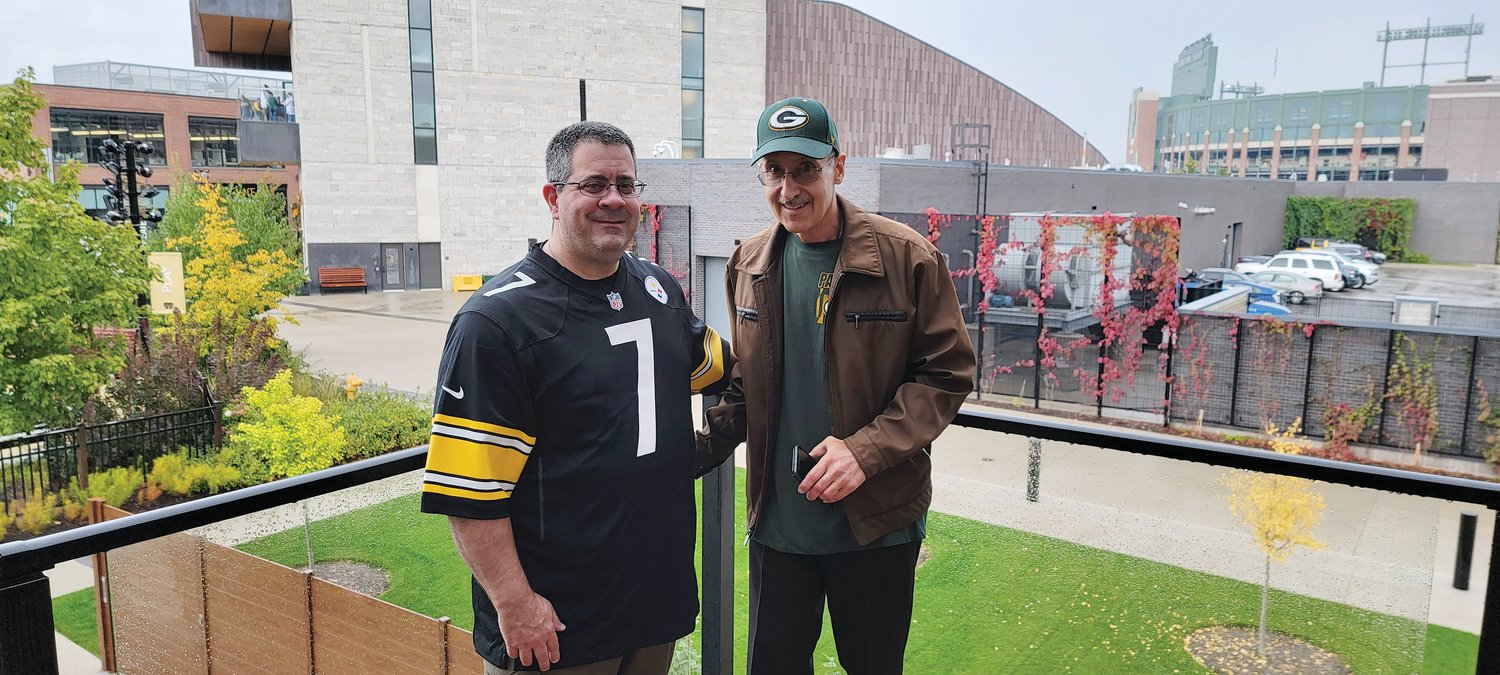 Father Dean Perri and Father Ray Suriani smile outside of Lambeau Field in Green Bay, Wisconsin on Oct. 3, before they watch the Green Bay Packers take on the Pittsburgh Steelers.